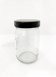 round glass jar with black cap