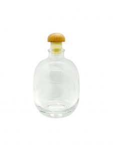 fat round liquor glass bottle with wood rubber cap
