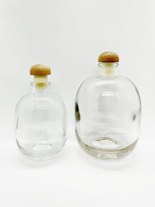 fat round liquor glass bottle with wood rubber cap