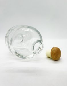 fat round liquor glass bottle with wood rubber cap