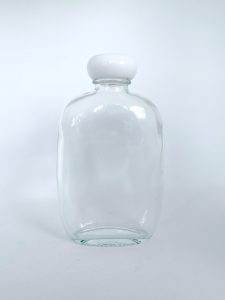 round fat clear glass bottle with plastic cap